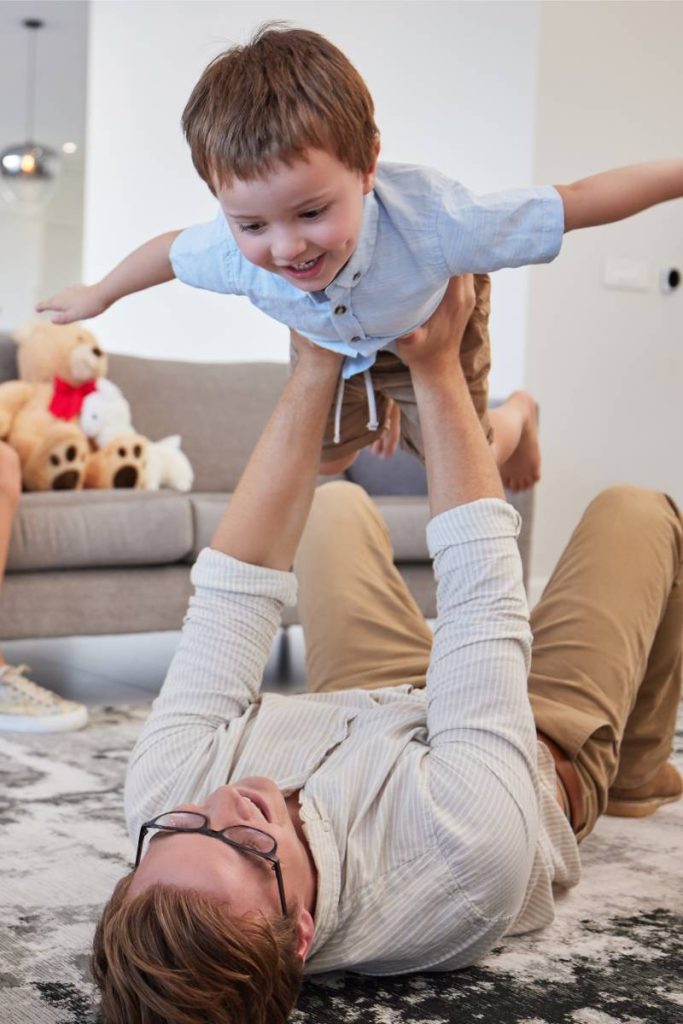 Family helicopter, child game and father with energy to relax with kid, love with care on the floor.